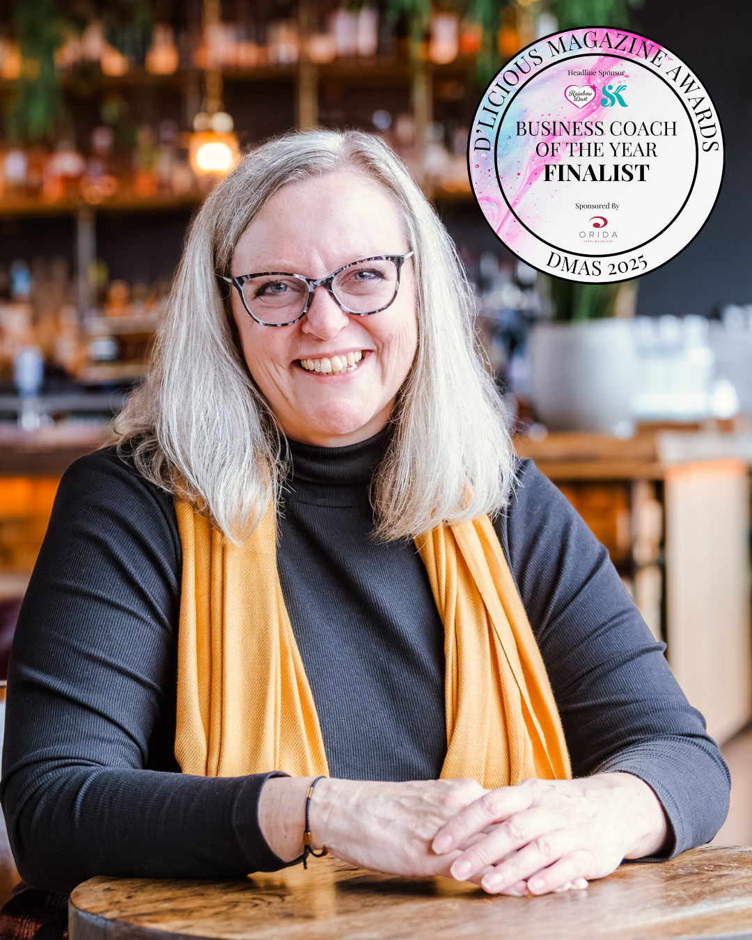 woman with grey hair, leaning on here hand and smiling. Annie Bennett from the Home Baking Business Academy