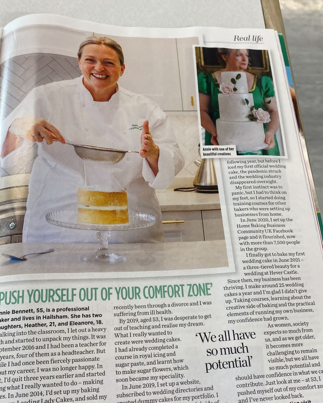 Annie Bennett featured in a 'Woman' magazine article titled 'Push Yourself Out of Your Comfort Zone', photographed in a white chef's jacket dusting a layered cake with icing sugar, with a second inset photo showing her holding a three-tiered white wedding cake.